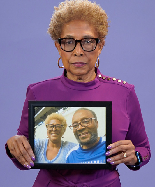 Anita Gaillard, holding a photo of her husband, Teal Clay Gaillard, who passed away from Alzheimer's disease